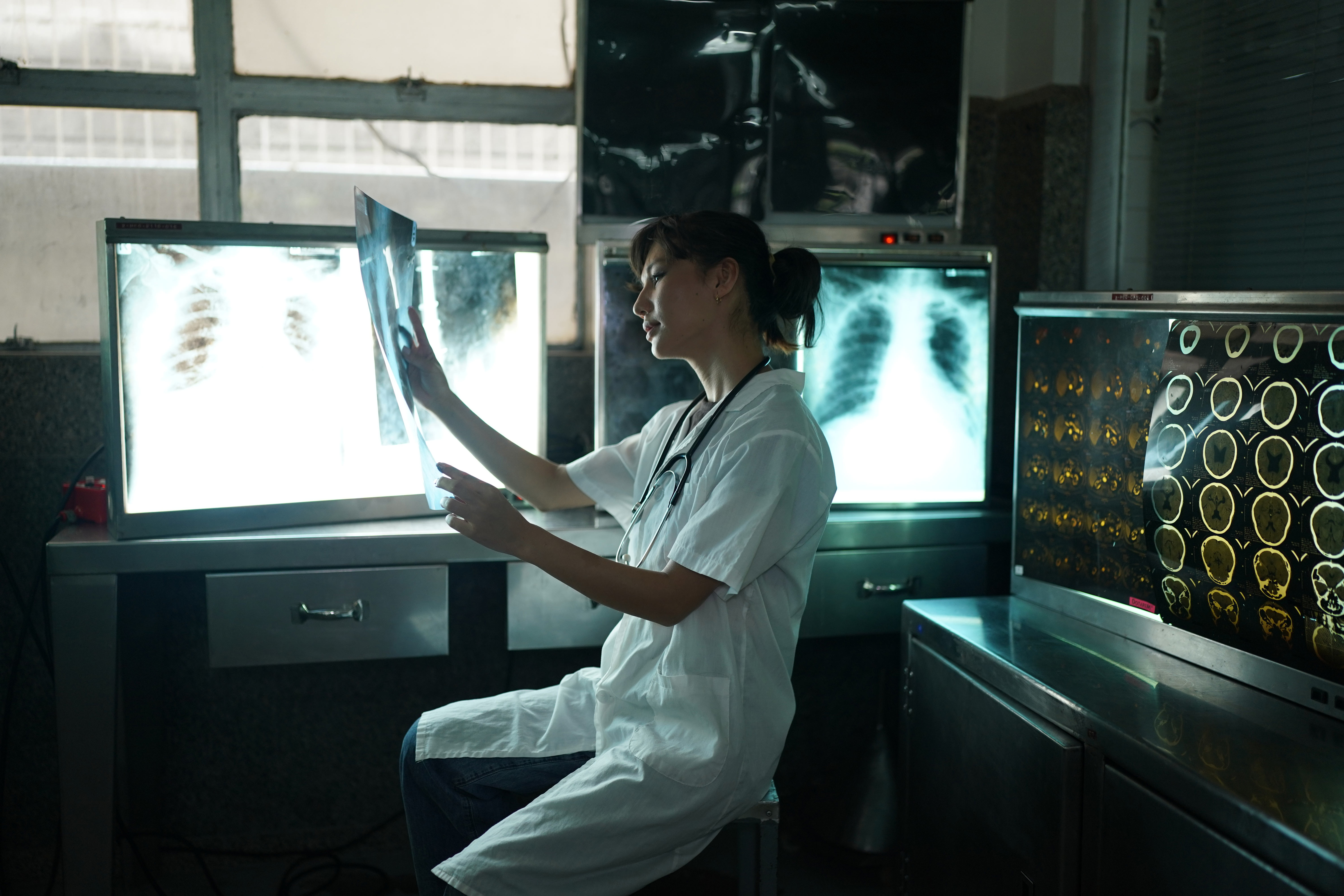 A medical professional looking at x-ray pictures